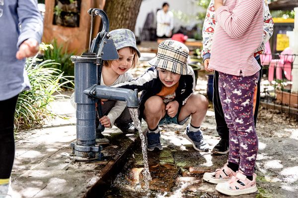 Children playing with water in the playground