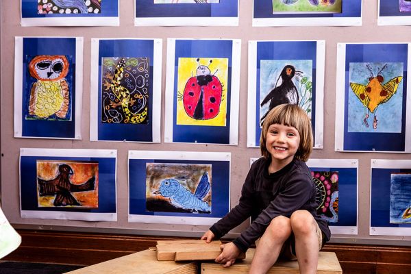 A child playing in front of some art work